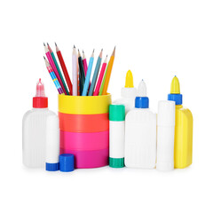 Different types of glue and pencils isolated on white