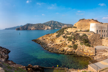 Obraz premium Historical fortresses on the edge of cliffs and secluded coves in the natural harbor of Cartagena, Murcia, Spain. one of the oldest cities in Europe