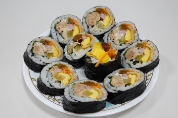 Delicious kimbap rolls filled with fresh vegetables, seasoned rice, and savory proteins, all wrapped in crisp seaweed. A perfect combination of flavor and texture in every bite.
