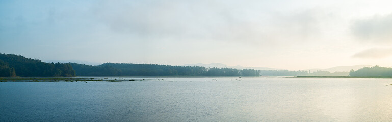 Panoramic beautiful view of sunrise over the lake, Nature background.