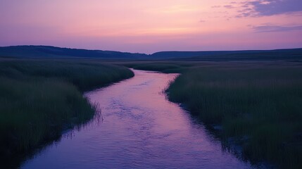 Calm river winds through a tranquil meadow at sunset with soft purple hues in the sky