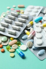 Various blisters with tablets on a colored background