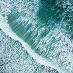 Fototapeta premium Overhead photo of crashing waves on the shoreline. Tropical beach surf. Abstract aerial ocean view High quality photo