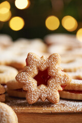 Star shaped Linzer Christmas cookie filled with strawberry marmalade, with bokeh lights in the background
