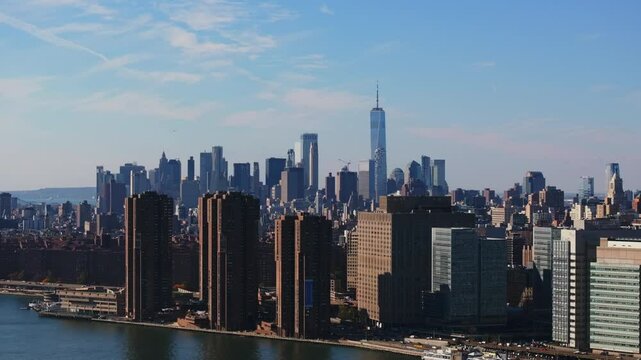 Waterside Plaza residential and business complex in Kips Bay section of Manhattan in front of East River, with One World Trade Center standing tall in the background