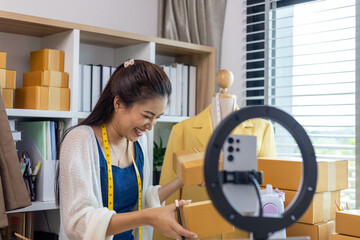 A woman who is running an online clothing business and is also a designer, working on designing...