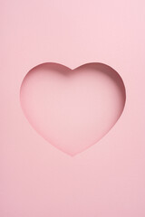 A vertical simple pink paper with a heart-shaped cutout, ideal for romantic or Valentine's Day themes. The minimalist design conveys love and tenderness, suitable for greeting cards or decoration