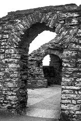 Fototapeta premium Open doors and Arches in black and white of an old Castle Ruin in Wales