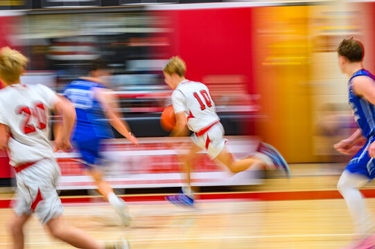 High School Basketball with motion blur showing the speed and movement of the young boys playing the game at Oxford HS in Upstate NY
