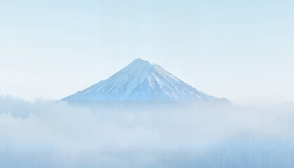 Ethereal Mountain Peak Rising Through Mystical Morning Mist in Serene Landscape