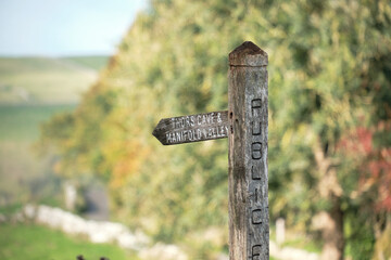 Wooden countryside footpath sign post in Wetton, Staffordshire, UK