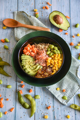 poke bowl with seeds and vegetables, avocado and salmon. homemade recipe fresh ingredients