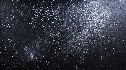 Obraz premium Thick layer of white chalk dust creates a striking contrast against a black background, highlighting the texture and depth of the chalk dust in the composition. Ample copy space available.