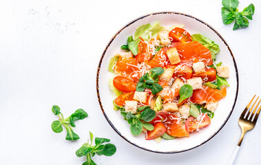 Foodie food salad with salmon, iceberg and lumb lettuce, croutons, parmesan cheese and caesar dressing. White background, top view