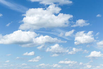 Beautiful soft gentle blue sky with white cirrus and cumulus fluffy clouds background texture