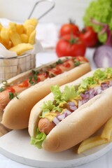 Tasty hot dogs served on white table, closeup