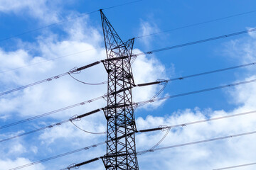 Photograph of the top section of an electricity Transmission Tower against a bright blue sky in regional Australia.