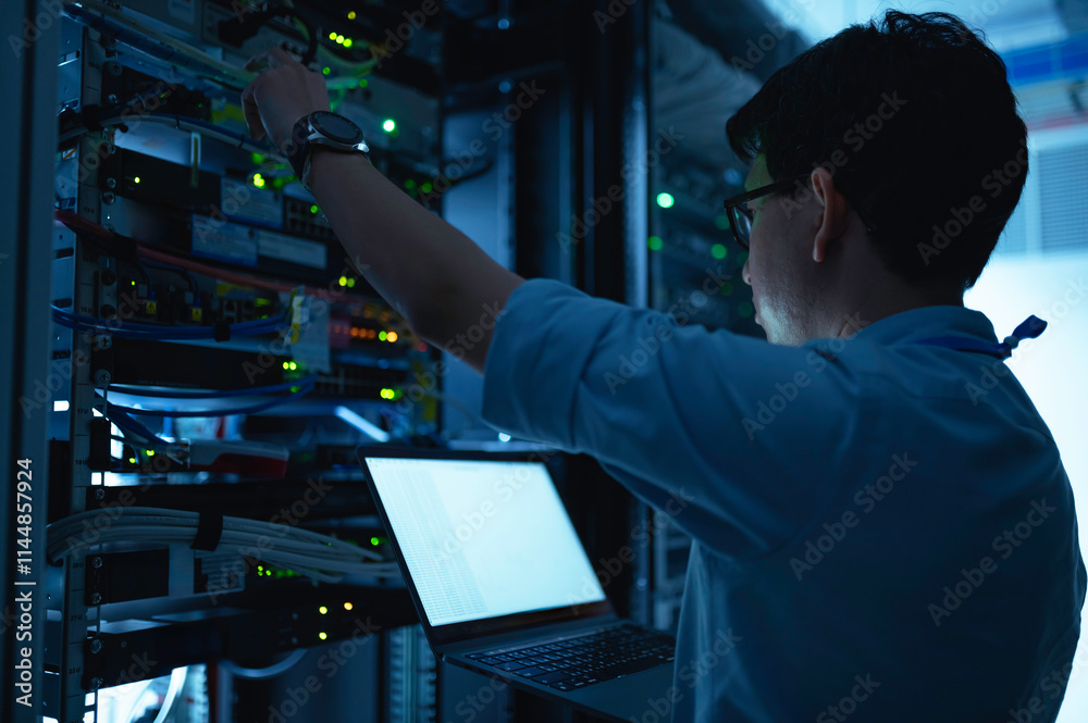 Wall mural computer engineer is setting up network in server room,systems maintenance technician,male engineer 