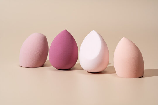 Soft cosmetic sponges for makeup application on beige background