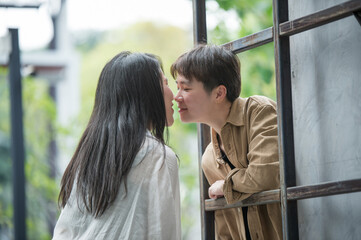 Happy Asian lesbian lgbtq couple dating in love kissing each other