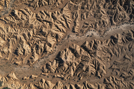 Aerial view of dramatic desert terrain and eroded formations