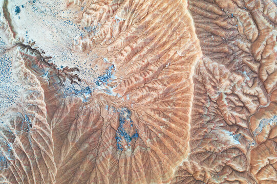 Aerial view of rugged desert terrain with erosion patterns