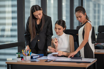Young Asian Businesspeople working in the office, meeting to discussing business plan, Power of cooperation