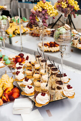 assorted desserts and fruits arranged on a multi-level stand.