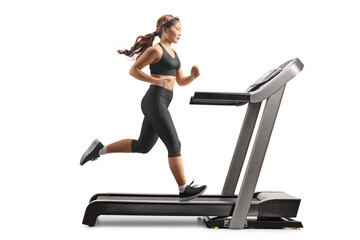 Full length profile shot of a young asian woman running on a treadmill