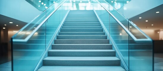Obraz premium Modern glass staircase in a bright, spacious building.