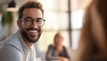 Fototapeta premium Smiling Man with Glasses in a Bright Office Environment