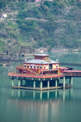 Dhari Devi Temple in Rudraprayag, Uttarakhand, stands on the Alaknanda River, connected by a bridge. This sacred shrine, surrounded by hills, is revered for protecting the region’s spiritual energy.