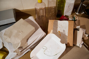 A cluttered kitchen counter full of discarded packaging and food containers