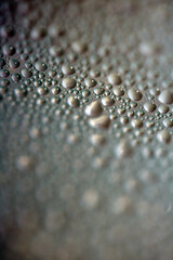 Close Up of Condensation Floating Liquid Water Bubbles and Drips on Glass from Rain