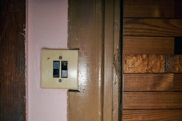 pink painted wall, wooden door and old light switch