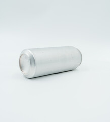 silver aluminum can with water droplets, lying on white surface
