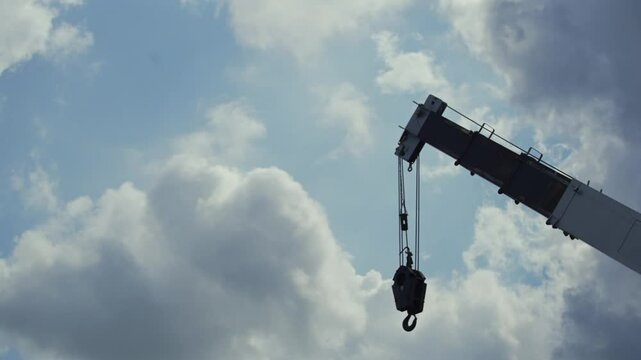 Heavy Duty Mobile Crane Arm and Hook Against Cloudy Sky, Construction Concept