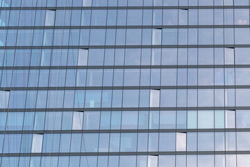 Modern glass building facade with reflections and clean lines