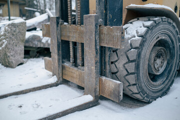 The loader forklift in the snow. Winter snowy day