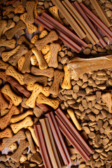 Top view of different types of dog food, dried treats.