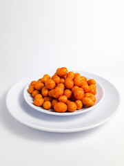 Spicy pilus served on a white plate, isolated on a white background. Perfect for a snack