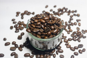 100% Arabica coffee beans in a glass cup, and decorated with coffee beans on the outside of the glass.