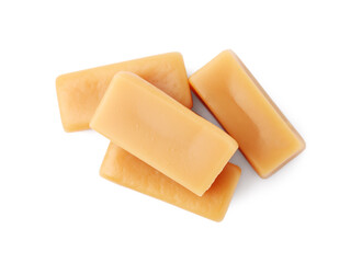 Tasty sweet caramel candies isolated on white, top view