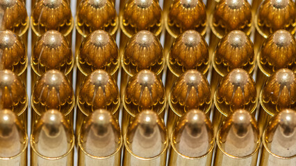 photo of a black pistol and bullets on a black background