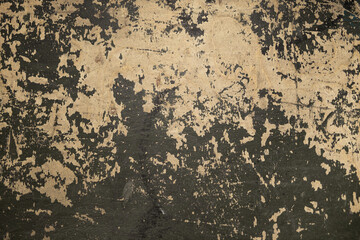 Close-up of a distressed grunge wall texture with peeling paint and weathered surface, showcasing an aged, industrial aesthetic. Ideal for backgrounds, design projects, or vintage themes
