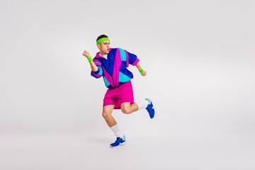 Energetic young man in colorful retro sportswear doing a dynamic workout