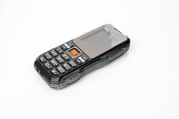Small push-button cell phone on a white background. Obsolete model. Space for inscription, space...