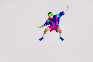 Young man in retro sportswear doing dynamic exercise, channeling fun and funky hipster vibes with a vintage style against