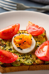 Healthy avocado toasts with eggs on black
