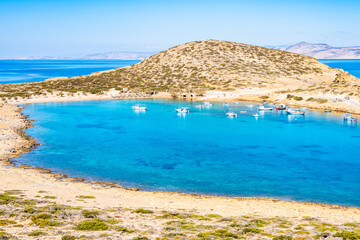 Boats in sea bay of Kalotaritissa with beautiful sandy beach, Amorgos island, Cyclades, Greece